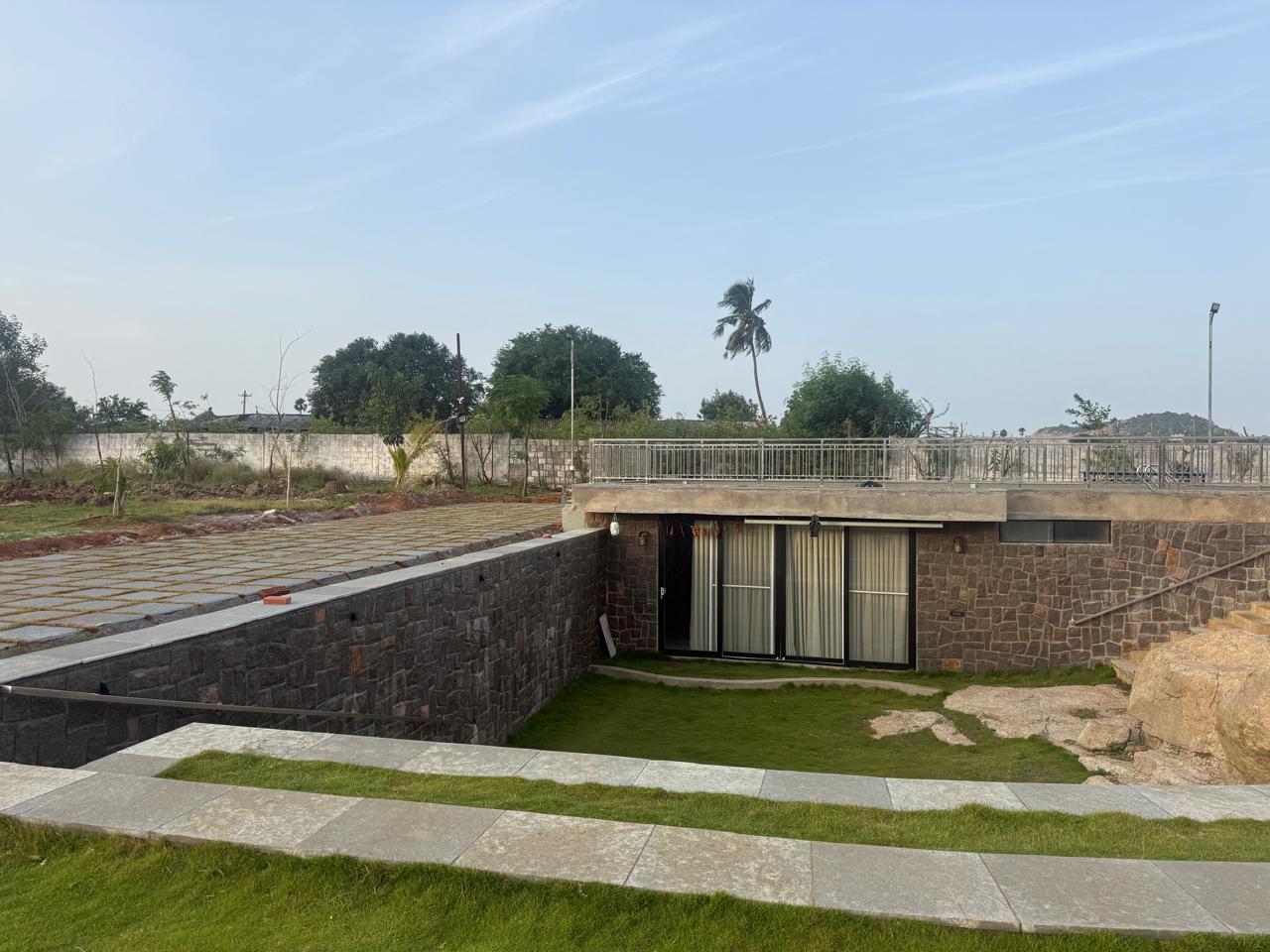 Underground entrance and terrace above, seen across the lawn