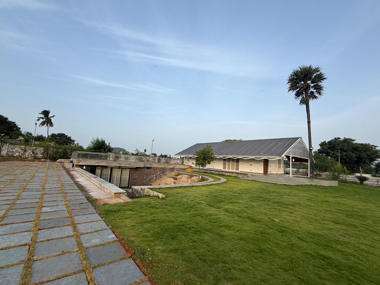 Farmhouse and underground wing connected by garden steps