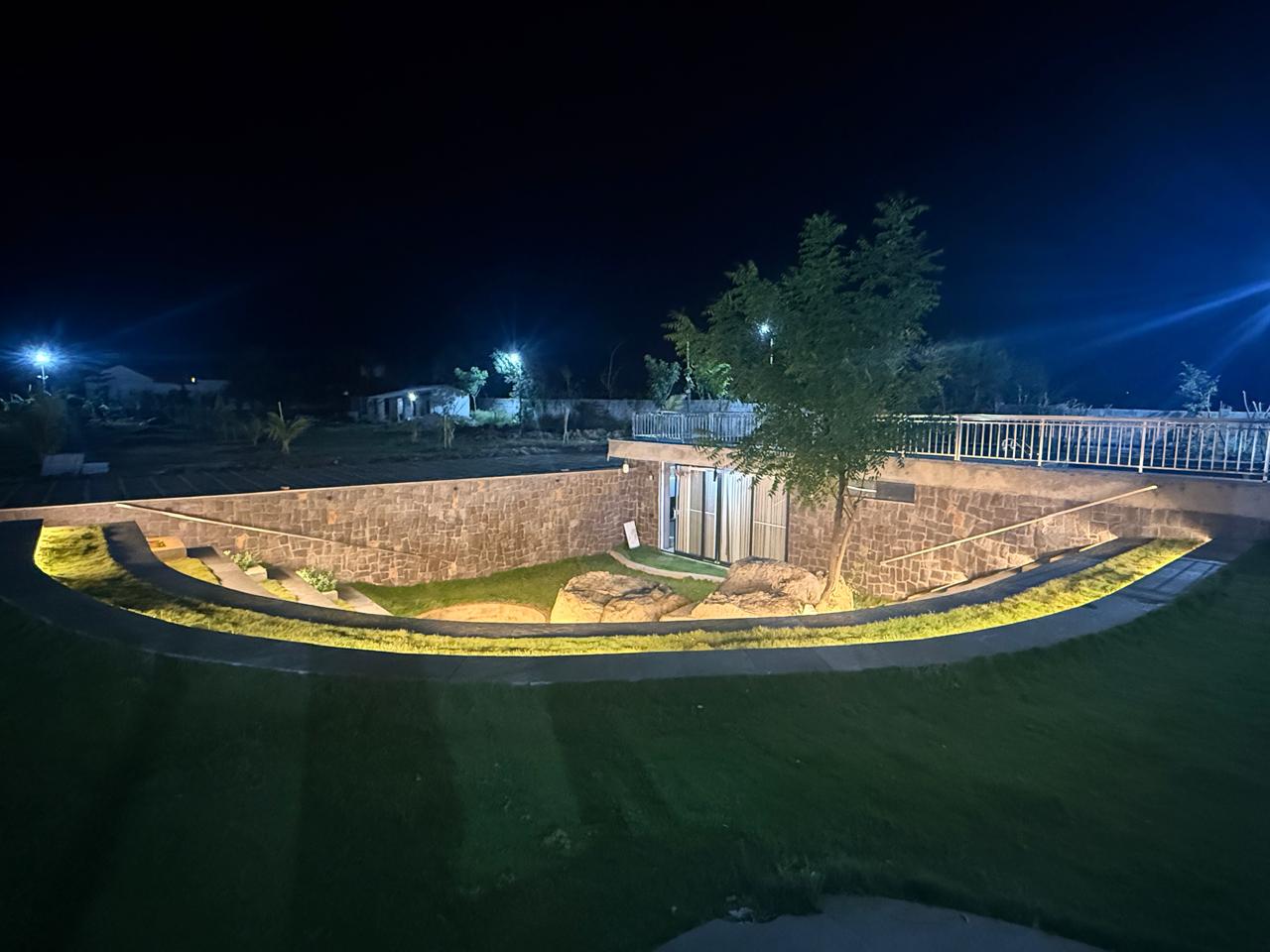 Aerial night view of the sunken stone courtyard and tree