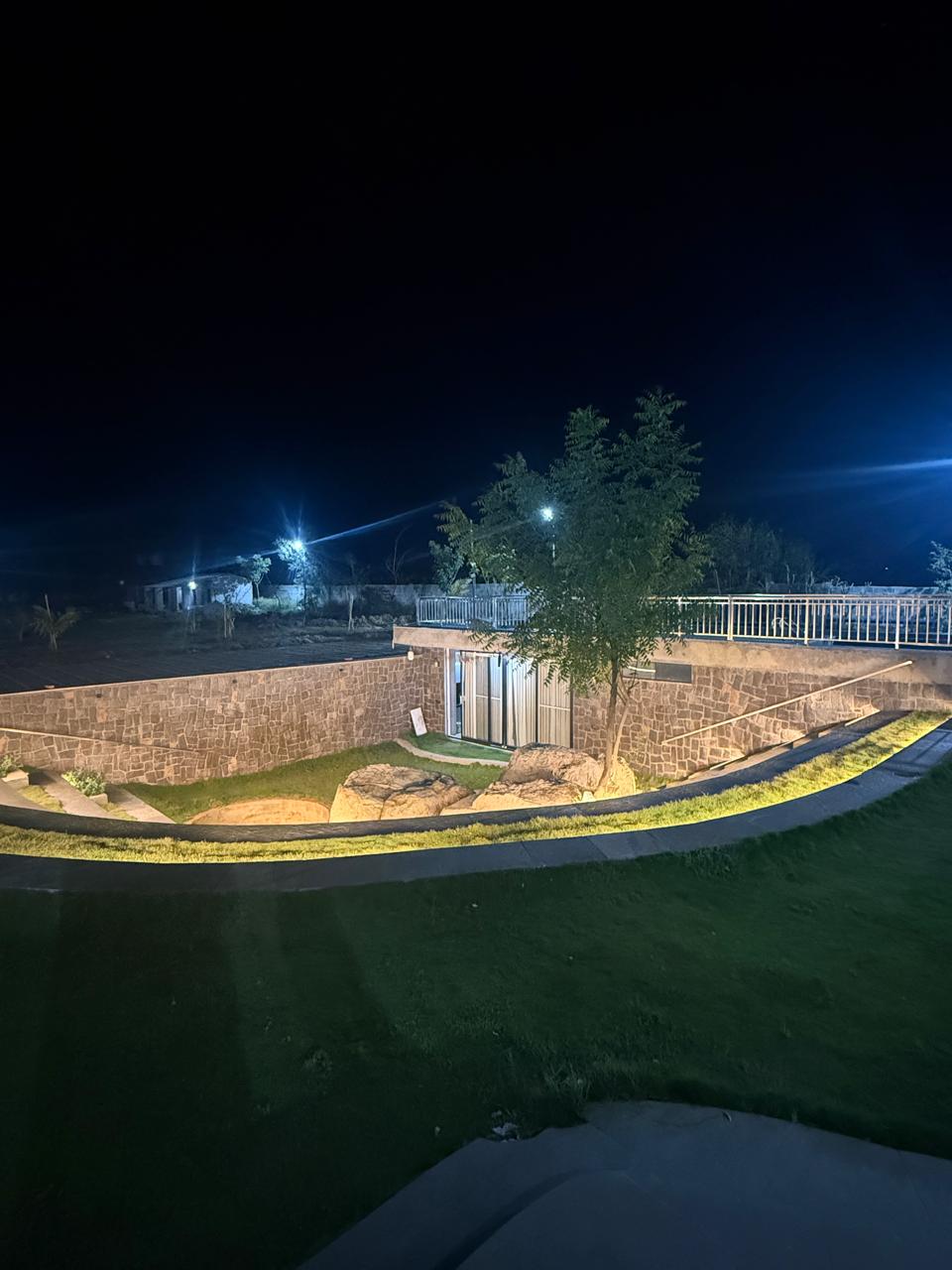 Another aerial night view of the lit stone courtyard